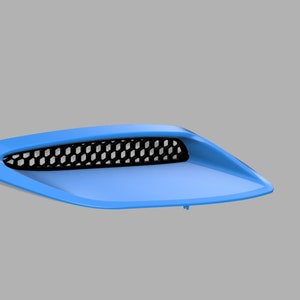 May include: A light blue car hood scoop with a black mesh grille.