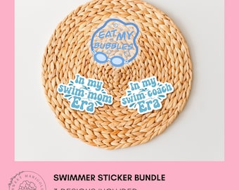 May include: A sticker bundle featuring three designs with blue text on a white background. The stickers include phrases like "Eat My Bubbles," "Swim Mom Era," and "Swim Coach Era." The stickers are arranged on a woven, circular placemat.