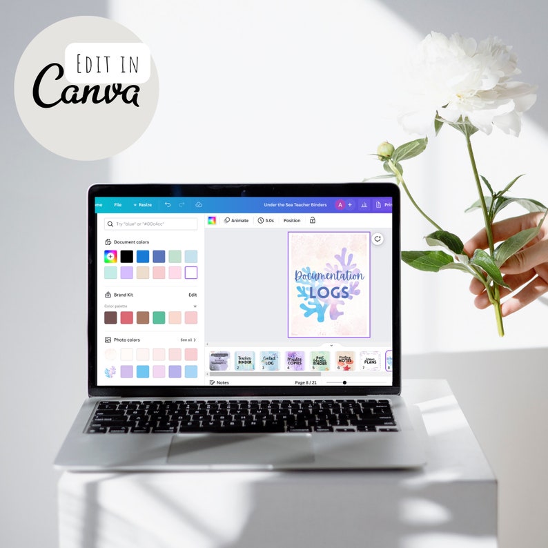 May include: A laptop screen displaying a Canva design for a teacher binder. The design features a coral reef with the text "Documentation Logs" in a blue and purple font.