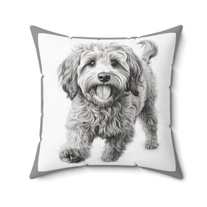 May include: A black and white illustration of a fluffy dog with its tongue sticking out, printed on a white throw pillow with a gray border.