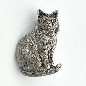 May include: A set of three ceramic mugs with a speckled, matte finish. The mugs are in shades of cream, light gray, and dark gray. Each mug has a simple, minimalist design, perfect for coffee or tea.