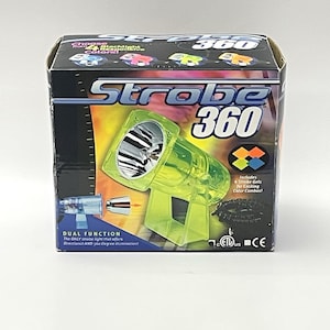 May include: A neon green Strobe 360 light in its original packaging. The box features the product name, a graphic of the light, and text indicating dual function and colour combinations. The light itself is a transparent green.