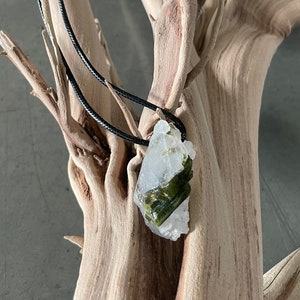 Green Tourmaline in Quartz mineral pendant on a black string