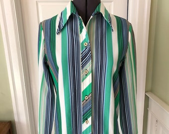 May include: A long-sleeved button-down shirt with a white background and vertical stripes in shades of green, blue, and black.