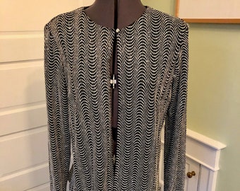 May include: Black and white patterned long-sleeve jacket with a wavy design. The jacket has a round neckline and fastens with a single button. The garment is displayed on a mannequin.