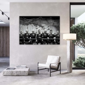 May include: Black and white illustration of seven men in suits, sitting in a row, with their hands raised in the air. They are connected by strings to a large, draped cloth above them.