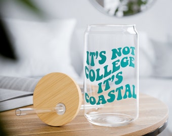 May include: A glass can with a bamboo lid and a straw. The can has the text "It's not college it's coastal" printed on it in teal.