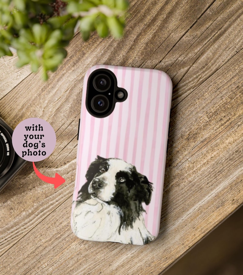 May include: A phone case with a pink and white striped pattern and a watercolor-style portrait of a black and white dog. The case has a camera cutout and the text "with your dog's photo".
