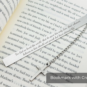 May include: Silver bookmark with a cross and a chain. The bookmark has the text "For God so loved the world, that he gave his only Son, that whoever believes in him should not perish but have eternal life."  John 3:16 is also engraved on the cross.