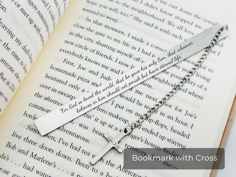 May include: Silver bookmark with a cross and a chain. The bookmark has the text "For God so loved the world, that he gave his only Son, that whoever believes in him should not perish but have eternal life."  John 3:16 is also engraved on the cross.
