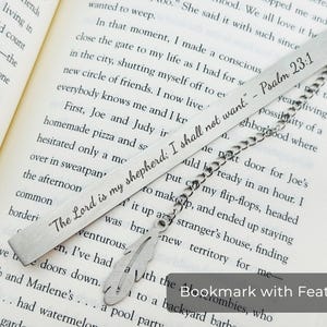 May include: A silver bookmark with a feather charm. The bookmark is engraved with the text "The Lord is my shepherd: I shall not want." - Psalm 23:1