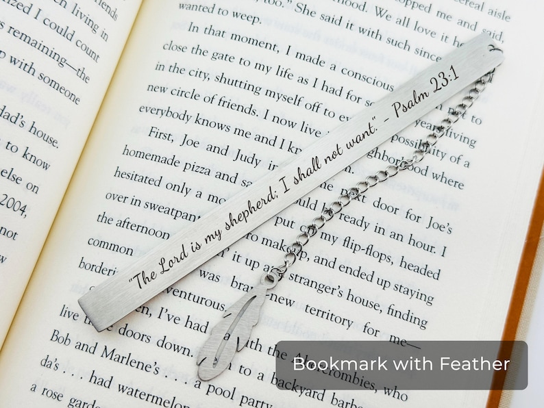May include: A silver bookmark with a feather charm. The bookmark is engraved with the text "The Lord is my shepherd: I shall not want." - Psalm 23:1