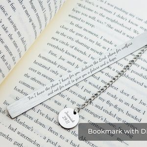 May include: A silver bookmark with a metal chain and a round metal disc with the text "Jeremiah 29:11" engraved on it. The bookmark has the text "For I know the plans I have for you, declares the Lord, plans for welfare and not for evil to give you a future and a hope." engraved on it.