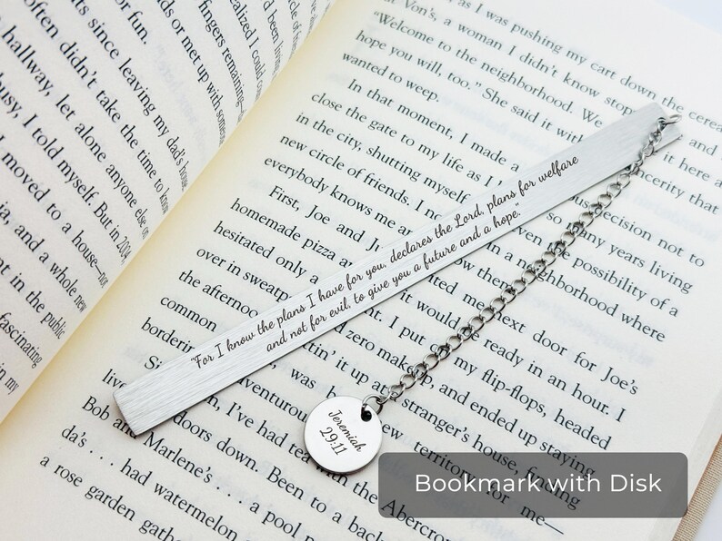 May include: A silver bookmark with a metal chain and a round metal disc with the text "Jeremiah 29:11" engraved on it. The bookmark has the text "For I know the plans I have for you, declares the Lord, plans for welfare and not for evil to give you a future and a hope." engraved on it.