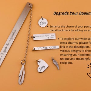 May include: A silver bookmark with the inscription "A book is a device to ignite the imagination."  The bookmark has a chain attached to it with various charms, including a feather, a heart with the name "Lexy" on it, a wing, a round charm with the name "Ana" on it, a rectangular charm with the inscription "I'm so proud of you, Dylan MOM", and a rectangular charm with the inscription "VII-VII-XXIII".