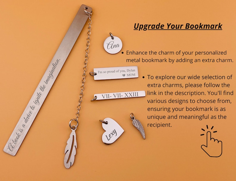 May include: A silver bookmark with the inscription "A book is a device to ignite the imagination."  The bookmark has a chain attached to it with various charms, including a feather, a heart with the name "Lexy" on it, a wing, a round charm with the name "Ana" on it, a rectangular charm with the inscription "I'm so proud of you, Dylan MOM", and a rectangular charm with the inscription "VII-VII-XXIII".