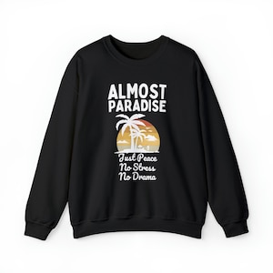 May include: Black sweatshirt with a white graphic design that says "Almost Paradise" with a palm tree and sunset graphic. The text below the graphic says "Just Peace No Stress No Drama".