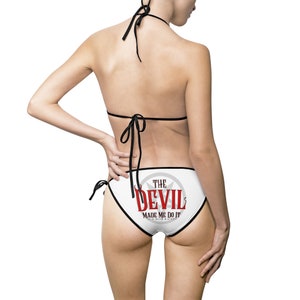May include: White bikini bottom with black trim and a graphic print of a red star with the text "The Devil Made Me Do It" in red and white.