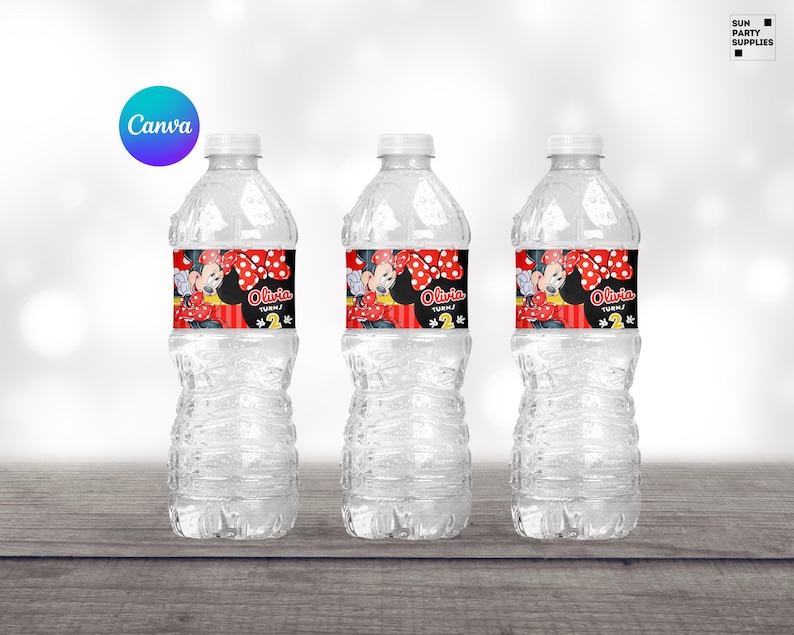 Op de afbeelding: Drie doorzichtige plastic waterflessen met zwarte en rode Minnie Mouse-thema labels. De labels tonen Minnie Mouse met een rode strik en stippen. De tekst op de labels luidt "Olivia wordt 2".