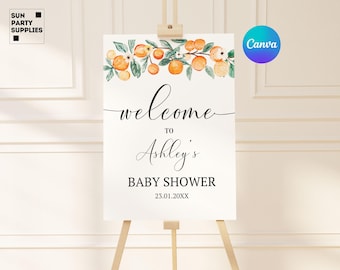 May include: A white welcome sign with orange blossoms and greenery. The sign reads "Welcome to Ashley's Baby Shower 23.01.20XX".