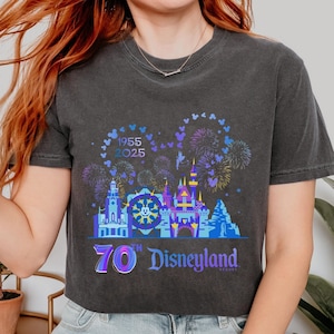 May include: A black cropped t-shirt with a graphic of Disneyland's iconic castle and fireworks. The graphic also includes the text "1955 2025" and "70th Disneyland Resort".