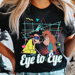 May include: Black t-shirt with a retro-style graphic of Goofy and a female character with the text "Eye to Eye".