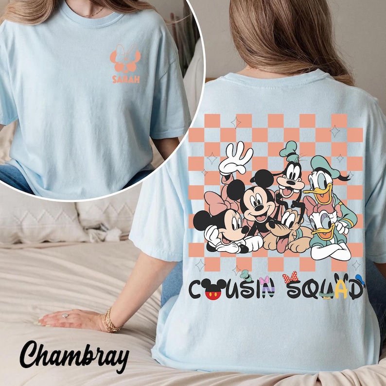 May include: Pale blue t-shirt featuring a Disney character graphic on the back, including Mickey and Minnie Mouse, Goofy, and Donald Duck. The words "Cousin Squad" are printed below. The front has the name "Sarah" and a character graphic.