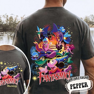 May include: Dark grey t-shirt with a vibrant graphic of Disney characters, such as Mickey Mouse, Ursula, and Ariel, and the word "Fantasmic!" in red. The shirt is comfort color and the word "Pepper" is in a speech bubble.