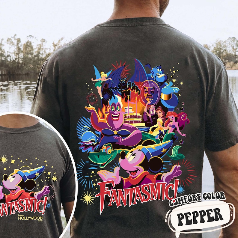 May include: Dark grey t-shirt with a vibrant graphic of Disney characters, such as Mickey Mouse, Ursula, and Ariel, and the word "Fantasmic!" in red. The shirt is comfort color and the word "Pepper" is in a speech bubble.