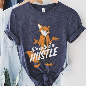 May include: A navy blue t-shirt with a cartoon fox wearing a tie and the text "It's called a hustle".