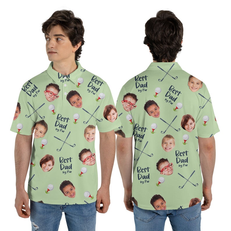 May include: Light green polo shirt with a repeating pattern of golf clubs, golf balls, and children's faces. The text "Best Dad by Par" is also printed on the shirt. The shirt has a collared neckline and short sleeves.