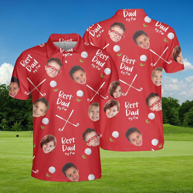 May include: Red polo shirt with a golf theme. The shirt features a pattern of golf balls, crossed golf clubs, and children's faces. Text on the shirt reads "Best Dad by Par" and "Dad by Par".