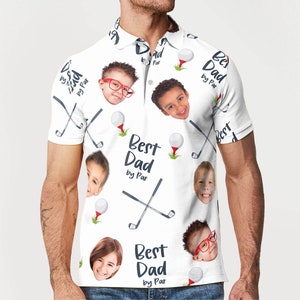 May include: White polo shirt with a repeating pattern of golf balls, golf clubs, and children's faces. The text "Best Dad by Par" is printed on the shirt. The shirt has a collared neckline and short sleeves.
