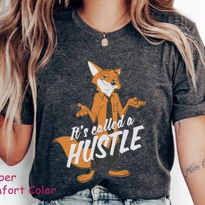 May include: A gray t-shirt with a cartoon fox wearing a tie and the text "It's called a hustle".