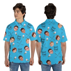May include: A light blue polo shirt with a repeating pattern of golf balls, golf clubs, and children's faces. The text "Best Dad by Par" is also printed on the shirt.