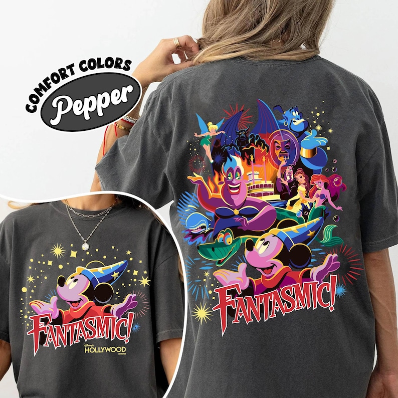 May include: Dark grey t-shirt with a vibrant graphic of Mickey Mouse in a sorcerer's hat, the text "Fantasmic!" and "Hollywood". The back of the shirt features various Disney characters.