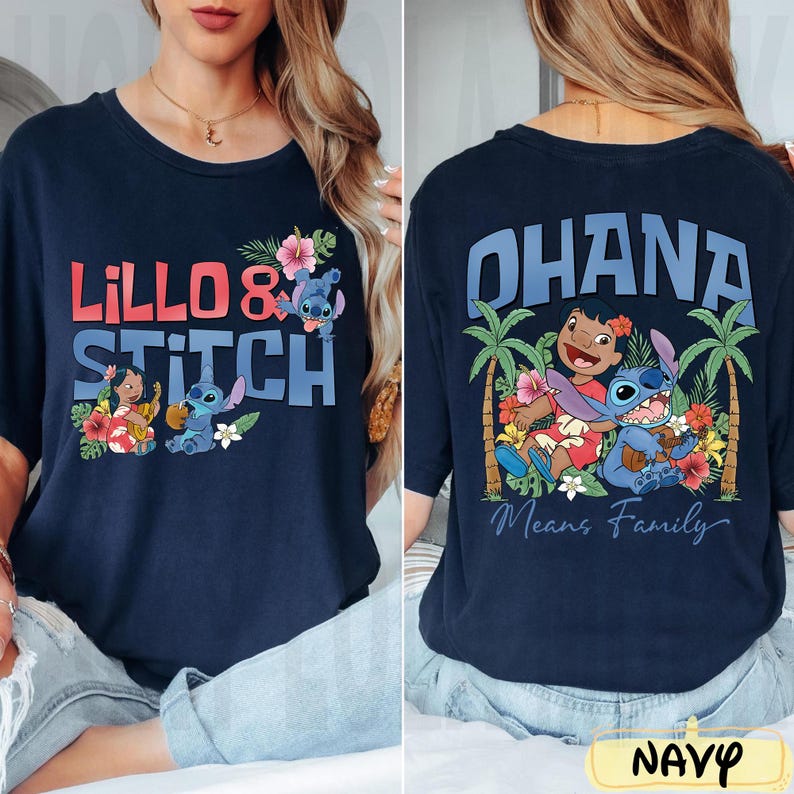 May include: Navy blue t-shirt featuring the words "Lillo & Stitch" in red and blue, with cartoon characters and floral accents. The back of the shirt displays "Ohana Means Family" with Stitch and Lilo illustrations.
