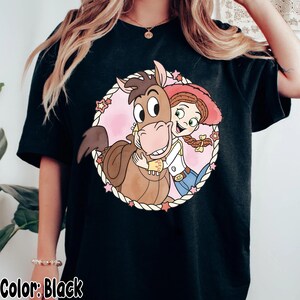 May include: A white ceramic mug with a black handle and the text "But First, Coffee" in a black, bold font. The mug is on a white surface.