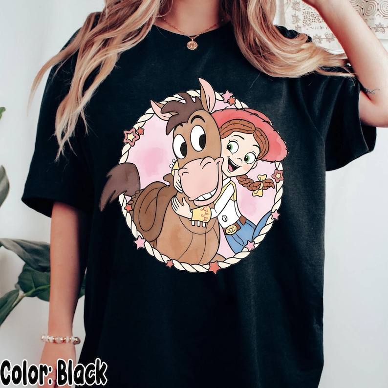 May include: A white ceramic mug with a black handle and the text "But First, Coffee" in a black, bold font. The mug is on a white surface.