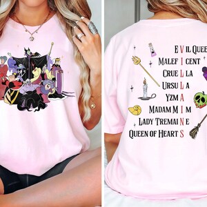 May include: Pink t-shirt with a graphic of Disney villains including Maleficent, Cruella de Vil, Ursula, and the Evil Queen. The back of the shirt has a list of the villains' names.