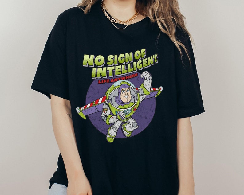 May include: Black t-shirt with a graphic of Buzz Lightyear from Toy Story. The graphic says "No Sign of Intelligent Life Anywhere".