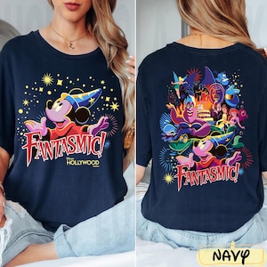 May include: Navy blue t-shirt with a vibrant graphic of Mickey Mouse in a sorcerer's hat and the text "FANTASMIC! Hollywood". The back of the shirt showcases various Disney characters. The word "NAVY" is at the bottom.