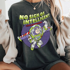 May include: A dark gray t-shirt with a distressed graphic of Buzz Lightyear from Toy Story. The graphic says "No Sign of Intelligent Life Anywhere".