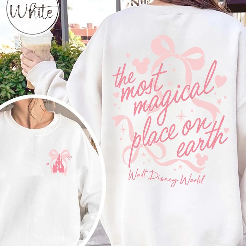 May include: White sweatshirt with a pink bow and the text "the most magical place on earth" in pink script. The sweatshirt also features a pink castle graphic and the words "Walt Disney World".