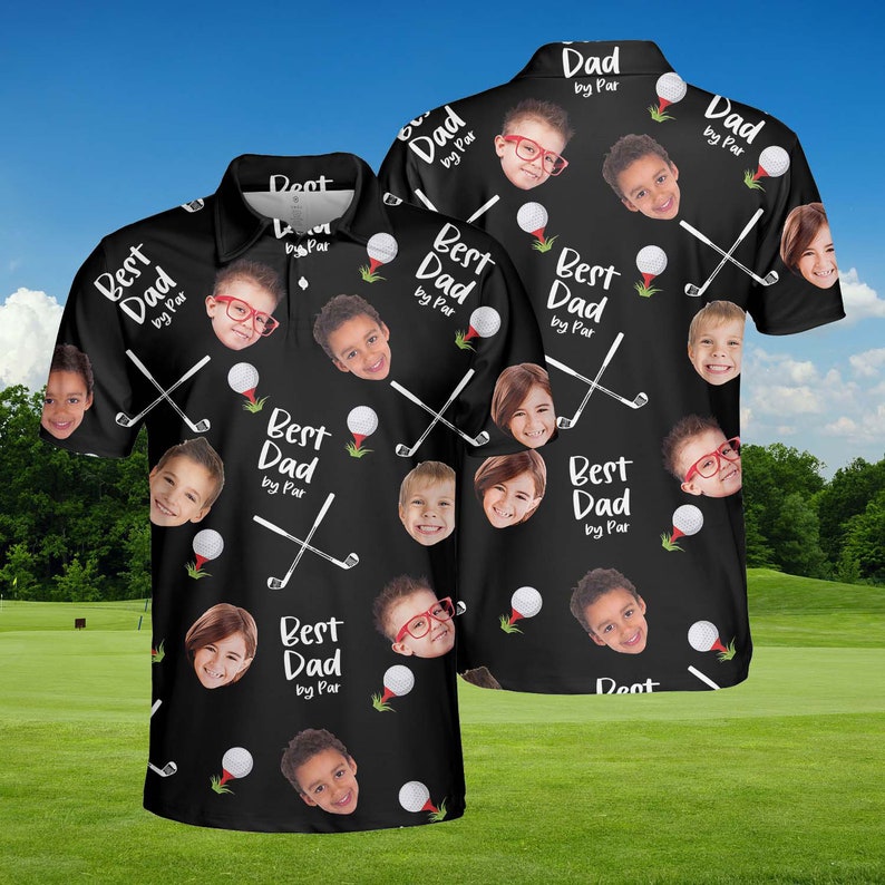 May include: Black polo shirt with a golf theme. The shirt features the text "Best Dad by Par" and images of children's faces, golf balls, and crossed golf clubs. The shirt has a collared neckline.