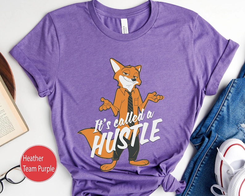 May include: Purple t-shirt featuring a cartoon fox wearing a tie and the text "It's called a hustle".
