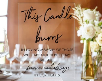 May include: A clear acrylic sign with black calligraphy that reads "This Candle Burns" and "In loving memory of those who are not here today, but are forever and always in our hearts".