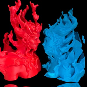 May include: Two 3D printed sculptures of figures with flowing hair, one red and one blue, facing each other.