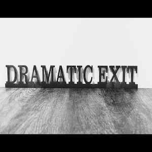 May include: Black wooden sign with the words "Dramatic Exit" in all caps.