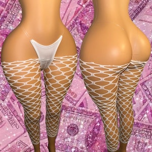 May include: White fishnet leggings and a matching white thong. The leggings feature a large diamond-shaped pattern. The thong has thin, clear straps. The background is pink with a dollar bill pattern.